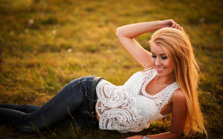 Woman lying field blonde denim - the ground in a field of grass free wallpaper