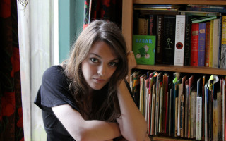 Woman leaning on shelf bookcase - anna findlay free wallpaper