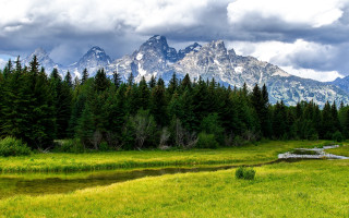 Grassy field stream mountains clouds - a stream free wallpaper