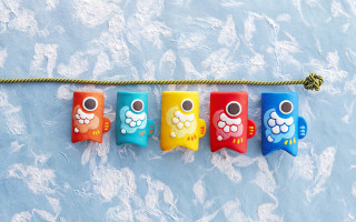 Colorful toothbrushes hanging blue clouds - a blue surface free wallpaper