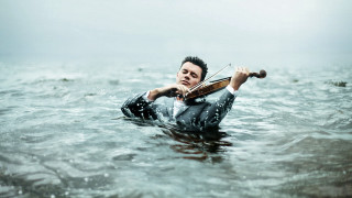 Man wet suit violin water - a violin free wallpaper