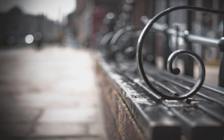 Metal bench sidewalk blurry background - a sidewalk free wallpaper