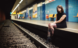 Woman sitting train track portrait - underground free wallpaper