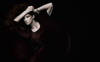 Woman black dress holding hair 2 - a picture in the dark free wallpaper