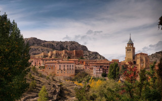 Village clocktower hillside mountains trees - a village free wallpaper