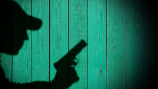 Shadow person gun green wall - noir free wallpaper