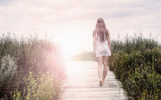 Woman walking flower field sunset - liminal free wallpaper for desktop