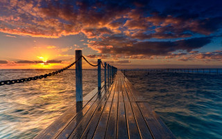 Sunset dock water clouds cityscape - arthur quartley free wallpaper