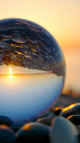 Glass ball sunset background rocks - a sunset in the background free wallpaper for mobile