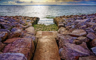 Stone wall walkway ocean cloudy - hdr free wallpaper