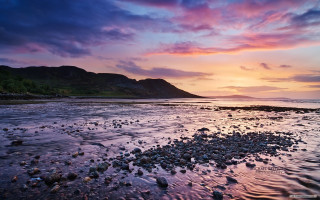 Sunset rocky beach mountain background - a sunset over a rocky beach free wallpaper