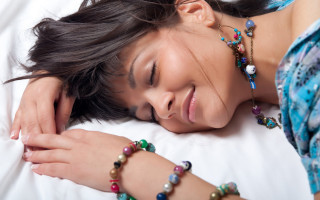 Woman smiling beaded bracelet bed - kitsch movement free wallpaper
