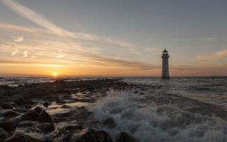 Lighthouse rocky shore sunset water 5 - a rocky shore free wallpaper
