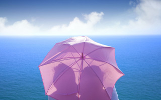 Pink umbrella beach sky mountain - a person holding free wallpaper
