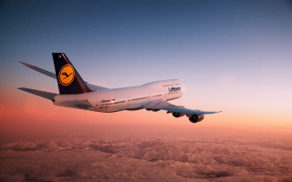 Large jetliner blue sky clouds 4 - sunrise free wallpaper