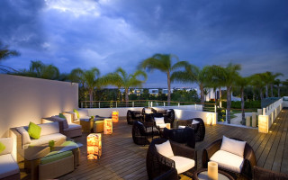 Deck chairs tables lights palm - a deck free wallpaper