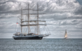 Large boat sailing ocean cloudy - cedric seaut free wallpaper