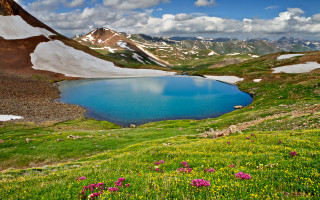Blue lake mountains flowers sunny - a blue lake free wallpaper