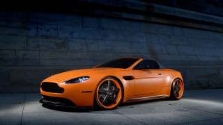 Bright orange sports car concrete - a concrete wall free wallpaper