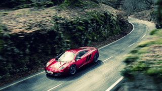 Red sports car winding forest - road free wallpaper for desktop
