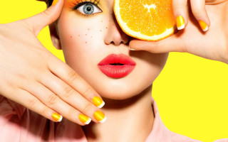 Woman orange face nails holding - an orange slice free wallpaper