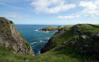Grassy hill rocky cliff island - a small island in the middle free wallpaper