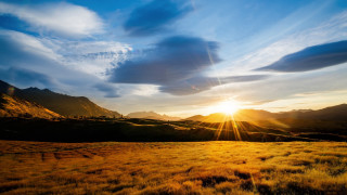 Sunset mountains ocean clouds horizon - the background and a sun free wallpaper