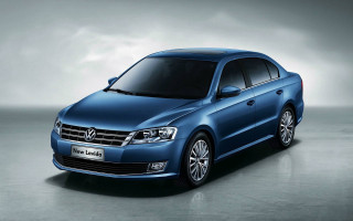 Blue volkswagen sedan dark room - a cloudy sky behind free wallpaper