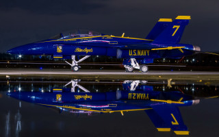 Blue fighter jet night reflections - top of a runway free wallpaper