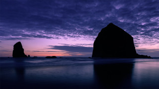 Purple sky rock formation beach - a rock formation in the foreground free wallpaper