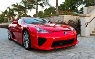 Red sports car cobblestone driveway - a stone wall free wallpaper