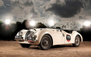 White sports car dirt field - under a cloudy sky free wallpaper