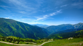 Scenic valley winding road mountains - road in the middle of it free wallpaper