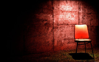 Chair dark wall light red - liminal space free wallpaper