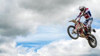 Dirt bike trick cloudy sky - a cloudy background free wallpaper
