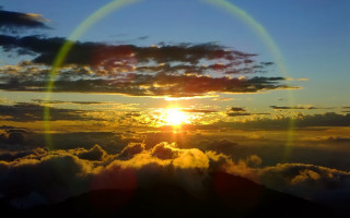 Sunset mountain rainbow halo beach - cloud below free wallpaper