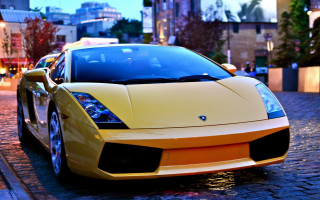 Yellow sports car city dusk - vibrant color free wallpaper