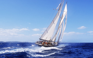 Sailboat ocean sunny day clouds - a sailboat free wallpaper