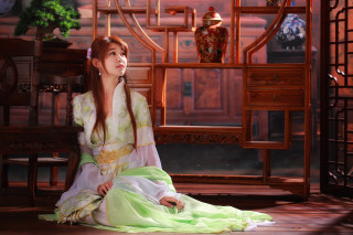 Woman green dress sitting wooden 2 - a wooden floor in front free wallpaper