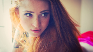 Woman red hair serious look - freckle free wallpaper