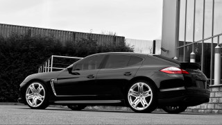 Black car building gate bushes - a black car free wallpaper for desktop