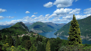 Scenic lake mountains trees town - a scenic view of a lake free wallpaper