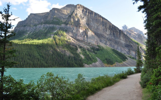 Mountain lake path forest sky 2 - a mountain in the background and trees free wallpaper