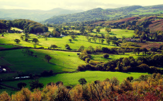 Green valley houses mountains clouds - a green valley free wallpaper