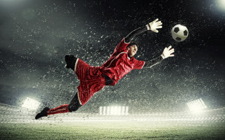 Soccer player red uniform kicking 2 - a soccer player free wallpaper