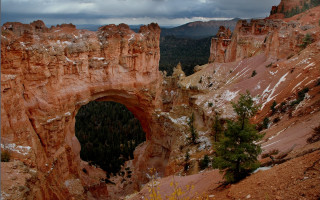 Mountain arch forest cloudy sky - a forest below free wallpaper