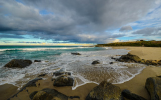 Beach rocks water cloudy sky 18 - a few cloud above free wallpaper