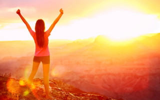 Mountain sunset woman arms raised - top of a mountain free wallpaper