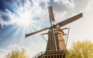 Windmill sunburst trees blue sky - a windmill free wallpaper