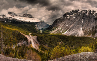 Mountain range winding road cloudy 5 - a cloudy sky above free wallpaper